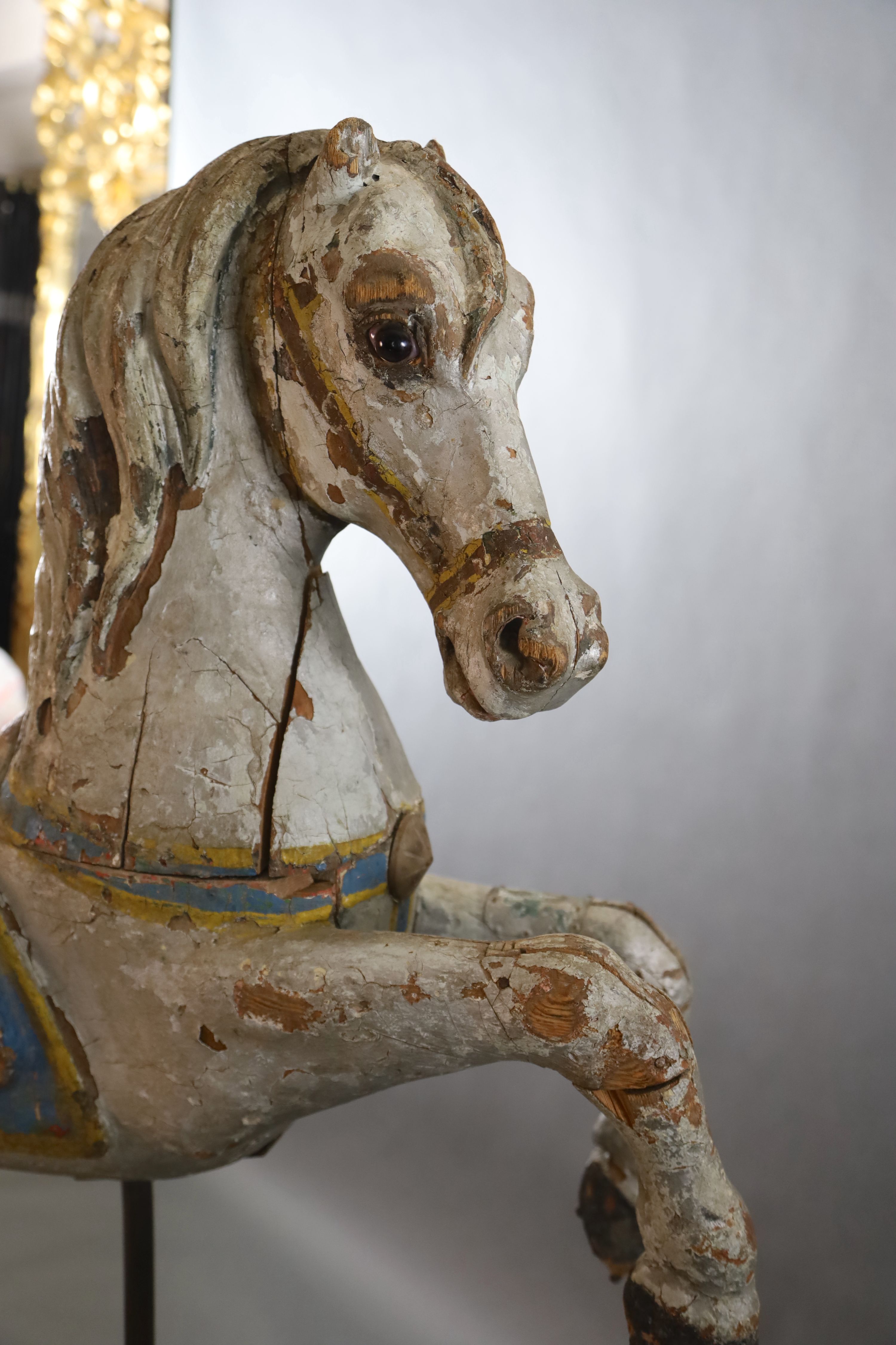 A 19th century, probably American, painted wood carousel horse, L.3ft 5in. H.3ft 7in. Overall H. when on stand 5ft 9in.